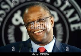 Mississippi State coach Jackie Sherrill and his wife, Peggy, are escorted  off the field after Mississippi's 31-0 win Thursday, Nov. 27, 2003, in  Starkville, Miss. For Sherrill and the Bulldogs, the season