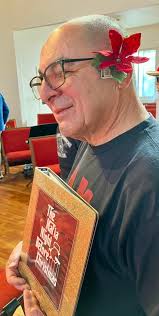 Gene, adorned by Oneida's ukulelei poinsettia