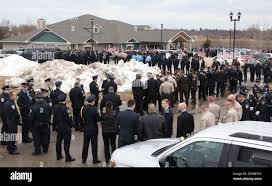 Officers wait outside DeFiore Funeral Home for the visitation for McHenry  County sheriff's Deputy Jacob Keltner