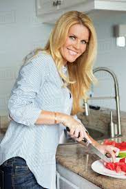 Blonde housewife cutting watermelon - Stock Photo - Dissolve