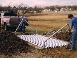 There are metal pipes that are laid in a strategic formation over a. Cattle Guards Rustic Fence Fence Company Serving Dallas Fort Worth