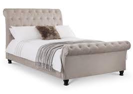 Bringing graceful curves to the classic bed shape, the sleigh design offers just the right amount of a joyfully unexpected flair in a familiar piece, and is especially sure to prove a hit in children's spaces! Ravello Mink Coloured Chenille Fabric Scroll Sleigh Bed