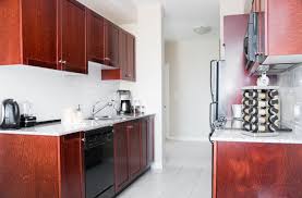 Two pendant lights hang above the expansive island with seating for four guests. Kitchen Designs For A Creative Condominium Select Kitchen And Bath