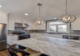 Contemporary kitchen equipped with a mix of dark base cabinets and modern white wall cabinets. 9 Top Trends For Kitchen Countertop Design In 2021 Best Countertops Countertop Design Kitchen Countertop Trends