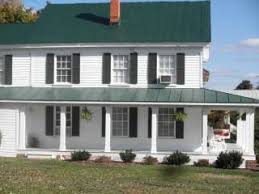 White columns and railings with dark brown copper gutters and matching accent roof. Tin Roofing Blog Washington Dc Area Green Roof Colores Para Casas Exteriores Pinturas Para Exteriores De Casa Contraventanas Exteriores