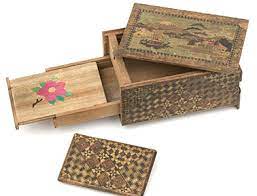 The first puzzle boxes did not have the elaborate decorative designs that are commonplace today. 1942 Japanese Himitsu Bako Puzzle Box Australia S Migration History Timeline Nsw Migration Heritage Centre