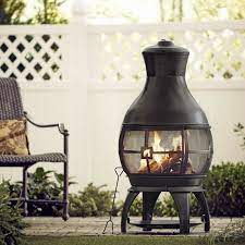 The chiminea's design allows it to be used in the rain without the water extinguishing its flame. Kramer 45 H Cast Iron Wood Burning Outdoor Chiminea In 2021 Diy Outdoor Fireplace Outdoor Fireplace Chiminea