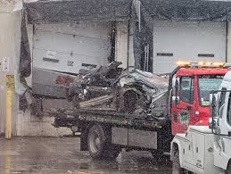 Police: 2 dead after car crashes into Detroit warehouse; driver in custody