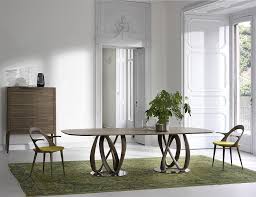 Simplistic in its form, yet very solid and elegant, this wooden table with a glass top constitutes a great proposition for one's contemporary decor. Amazing Contemporary Dining Tables Steal The Show With A Sculptural Base