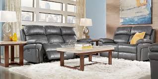 A worn brown leather sofa, blue velvet tufted ottoman, wingback chairs and an eclectic mix of navy and natural textiles mix perfectly in this living room. Blue Slate White Living Room Furniture Decorating Ideas