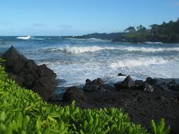 Travel to a black sand beach and visit tropical waterfalls & rainforests. The Black Sand Beaches Of Hawaii