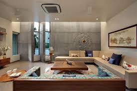 Centre modern furniture around a cubic rug. Krishnashray A T Associates Hall Interior Design Bungalow Interiors Living Room Designs India