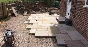 Fill the gaps between slabs with more sand. How To Lay A Patio Step By Step Guide