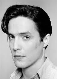 John Stoddart, a well-known portrait photographer, has taken several  portraits of celebrities—including Hugh Grant—often in his Chelsea studio  around the early 1990s. These black and white portraits show a  young-looking Grant and