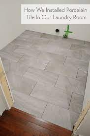 We prefer ceramic or porcelain tile in bathrooms. Laying Porcelain Tile In The Laundry Room Young House Love Laundry Room Flooring Room Flooring Flooring