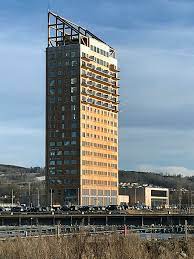 It is a small, densely populated area surrounded by countryside and farms on the eastern shore of norway's largest lake: Brumunddal Store Norske Leksikon
