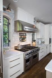 Fabulous Kitchen Features A Stainless Steel Kitchen Hood Which Stands Over A Marble Subway Tiled Back Trendy Farmhouse Kitchen Kitchen Range Hood Kitchen Hoods