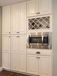 Cream Colored Cabinetry With Built In Wine Rack And Microwave Oven Built In Wine Rack Small Basement Kitchen Kitchen Cabinet Wine Rack