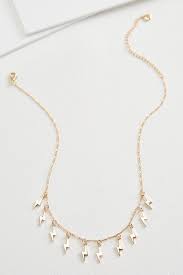 Depicted as a yellow lightning bolt flashing from a white cloud. Versona Lightning Bolt Necklace