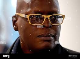 Kia Walker, mother of Tommy Schaefer, sheds tears as she talks with  reporters after Heather Mack, and Mack's daughter, Walker's granddaughter  Stella, arrived back in the U.S. at O'Hare International Airport Wednesday,