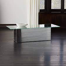 Beautiful wood grain, sculptural legs with gold painted feet and an opening with a center mirror. Muse Mirror Coffee Table Reviews Cb2