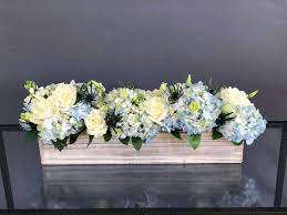 Long Wood Box Arrangement For A Table With White Roses And Blue Hydrangeas Blue Flower Arrangements Beautiful Flower Arrangements Blue Hydrangea Centerpieces