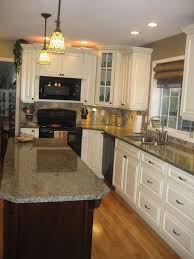 The transitional kitchen's masterpiece is the gorgeous hood with a great island! Light Grey Grey Kitchen Cabinets With Black Countertops Novocom Top