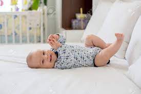 Cute Little Smiling Newborn Baby Boy Playing In Bed In The Morning Stock Photo Picture And Royalty Free Image Image 91109293
