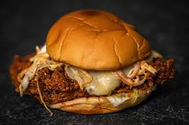Nashville hot chicken sandwich topped with coleslaw, comeback sauce, and pickles; This Spicy Chicken Burger In Dubai Measures 8 000 On The Scoville Scale Restaurants Time Out Dubai
