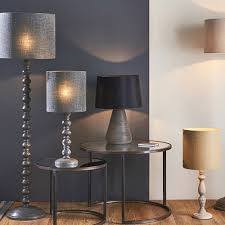 The simple, oversized metal shape is inspired by old lamps from places like factories and theatres. Joss Single Light Floor Lamp Dark Grey Wash Wood Moonlight Design