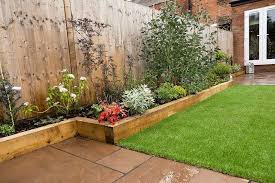 The Raised Sleeper Beds Work Perfectly In This Low Maintenance Garden Garden Design Back Garden Design Garden Layout