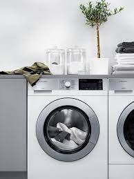 modern laundry room features a white washer and dryer tucked under a gray countertop topped modern laundry rooms laundry room colors laundry room color schemes