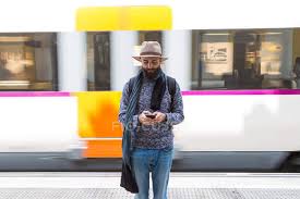 Download as svg vector, transparent png, eps or psd. Front View Of Man In Hat Browsing Smartphone Over Moving Train On Background Stylish Platform Stock Photo 171174506