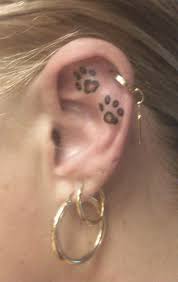 So let choose best print tattoos from shown designs. Black And Grey Two Paw Prints Tattoo On Girl Inside The Ear