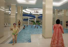 A Woman In Traditional Korean Costume Watches As A Student Leaves A Swimming Pool Of Kim Il Sung University In Pyongyang North Korea Korea Inside North Korea