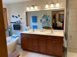 It has a black mirror with lights that is completed by the table drawers placed in front of the glass for finishing your makeup. Tony Redd Renovations