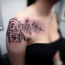 Gerber daisy tattoo design on upper back. Updated 65 Graceful Shoulder Tattoos For Women August 2020