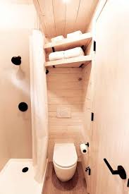 A tiny bathroom still comes with walls—so use height to your advantage. Shower Tiny House Bathroom Ideas Trendecors