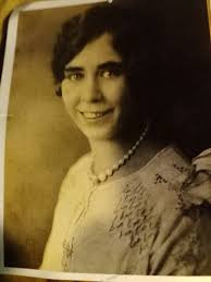 Who is the lady hosting a darts event and who is the gentleman accompanying  her?