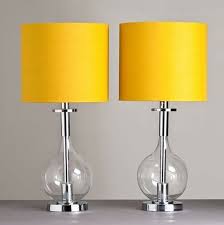 A modern graphite grey bedroom with a white bed, lights and photos and lemon yellow bedding to spruce up the space. Yellow Yellow Bedroom Yellow Living Room Yellow Lamp