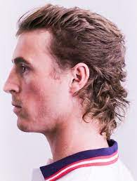 Pushed Back Top With Curled Mullet This Richly Textured Mullet Pairs A Brushed Back Style On Top W Mullet Hairstyle Mullet Haircut Mens Hairstyles Thick Hair