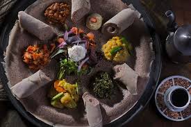 This is usually in the form of wat, a thick stew, served atop injera, a large sourdough flatbread, which is about 50 centimeters (20 inches). Enssaro Ethiopian Restaurant Home Oakland California Menu Prices Restaurant Reviews Facebook