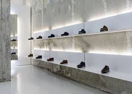 White Shelves Hang From Concrete Walls At Shoe Shop By Elia Nedkov Butikkinterior Interior Designer