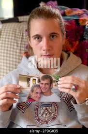 Ashley Painter of Pandora, Ohio, holds a photo, Wednesday, Dec. 28, 2005,  in Pandora, of her with her boyfriend, Manuel Bartsch, who was taken into  immigration custody in Cleveland last week after