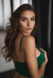 A close up of a woman in a green lingersuit posing for a picture - SeaArt AI