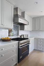 Give your kitchen cabinets a fresh new look with paint. Ben Moore Brushed Aluminum Gray Cabinet Paint Light Gray Counters Blue Range Cooktop Wall Grey Painted Kitchen Trendy Kitchen Tile Stained Kitchen Cabinets