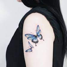 Blue Butterfly Tattoo On The Left Upper Arm Butterfly Tattoos For Women Blue Butterfly Tattoo Butterfly Tattoo Designs