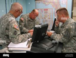 Sgt. Maj. Isham Fugate (left), Maj. Albert Dixon and Maj. Joseph Lietz of  the Florida Army National Guard's 50th Area Support Group plan logistics  operations in preparation for Tropical Storm Fay from