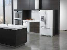 The dominating white cabinetry is interspersed by black appliances, including stove, microwave, and exhaust hood. White Vs Black Vs Stainless Steel Appliances