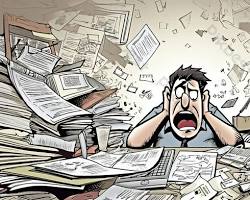 Imagem de Person with head in hands, surrounded by papers